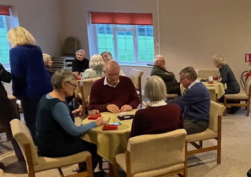 Room showing people playing bridge